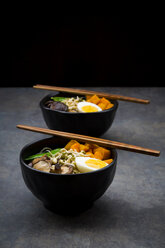 Ramen with noodles, egg, hokkaido pumpkin, mung sprout, shitake mushroom in bowl, chopsticks - LVF06454
