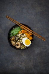 Ramen with noodles, egg, hokkaido pumpkin, mung sprout, shitake mushroom in bowl, chopsticks - LVF06456