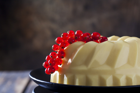 Custard with red currants on plate stock photo