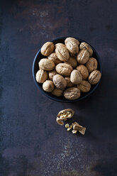 Bowl of walnuts on dark metal - CSF28573