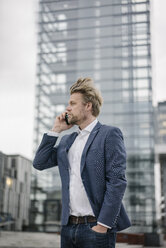 Businessman on cell phone in the city - JOSF02055