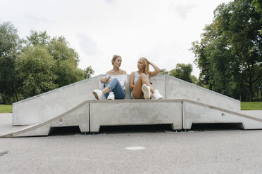 Zwei junge Frauen unterhalten sich in einem Skatepark - KNSF03051