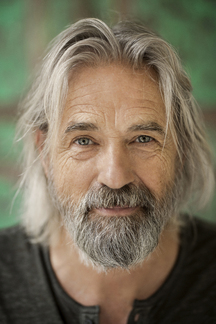 Portrait an attractive middle-aged man with a gray beard. - SuperStock