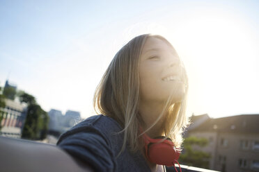 Portrait of happy young woman enjoying sunlight - KNSF03150