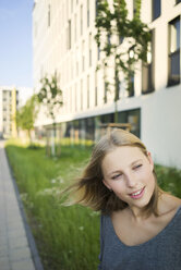 Portrait of blond young woman with blowing hair - KNSF03161