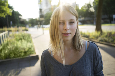 Portrait of blond young woman at backlight - KNSF03163