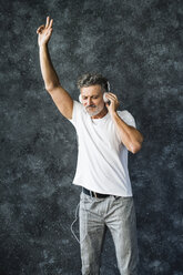 Mature man having fun listening music, wearing headphones - HAPF02461