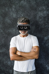 Mature man looking through VR glasses backwards - HAPF02465