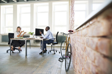 Colleagues in start-up company, sitting in office, discussing - HAPF02495