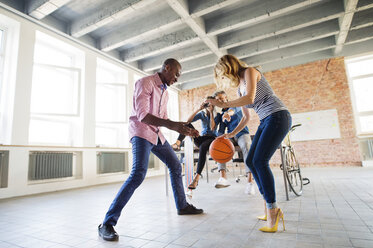 Collegues playing basketball in their new office - HAPF02500