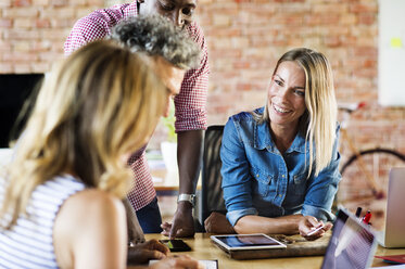 Business people working in office of a start-up company, having a meeting - HAPF02504