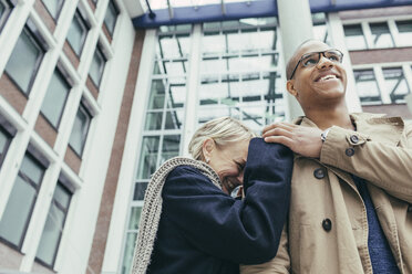 Happy mature woman and young man, smiling - KMKF00080