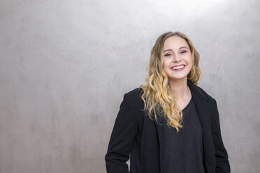 Portrait of laughing young woman - FMKF04676