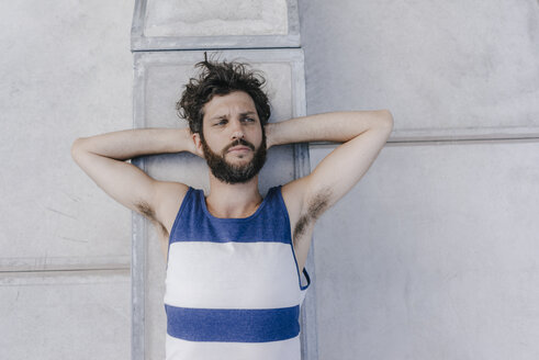 Portrait of serious man lying in skatepark - KNSF03214