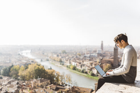 Italien, Verona, Tourist mit Laptop, Aussichtspunkt - GIOF03580