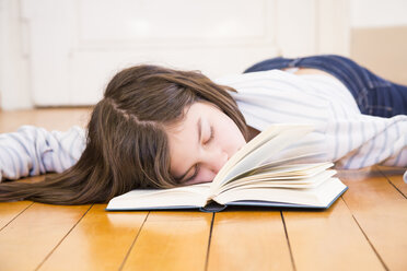 Mädchen mit Buch auf dem Boden liegend schlafend - LVF06499