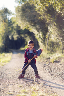 Boy with a hobby horse standing on way - XCF00163