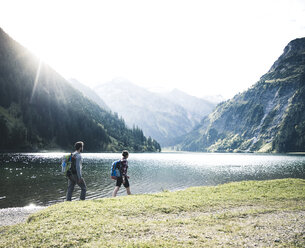 Austria, Tyrol, young couple hiking at mountain lake - UUF12468