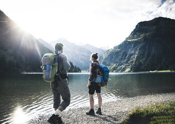 Austria, Tyrol, young couple hiking at mountain lake - UUF12471