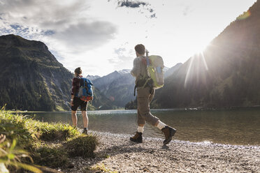 Austria, Tyrol, young couple hiking at mountain lake - UUF12472