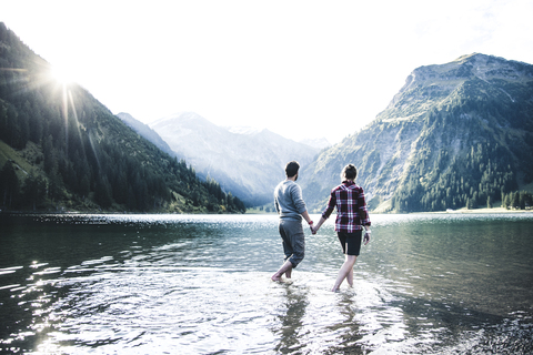 Austria, Tyrol, hiking couple refreshing in mountain lake stock photo