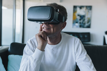 Man wearing VR glasses in an apartment - MFF04245