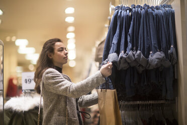 Young woman choosing clothes in shop - SGF02126