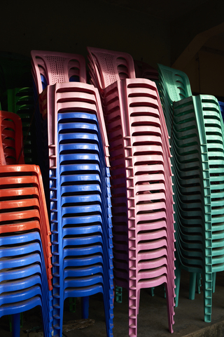 Stacks of coloured plastic chairs stock photo