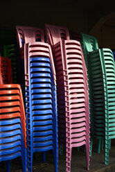 Stacks of coloured plastic chairs - IGGF00249