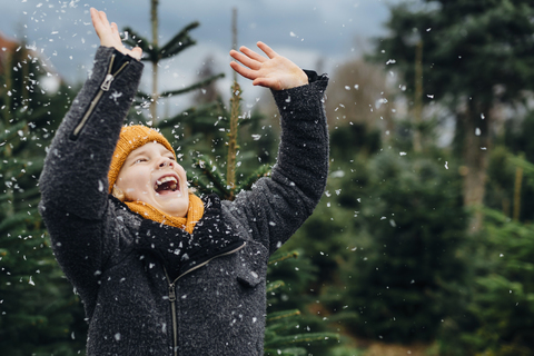 Kleiner Junge hat Spaß mit Schnee vor Weihnachten, lizenzfreies Stockfoto