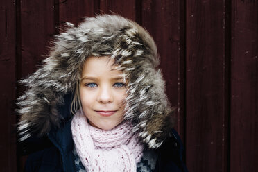 Portrait of a little girl wearing windswept fur hood - MJF02254