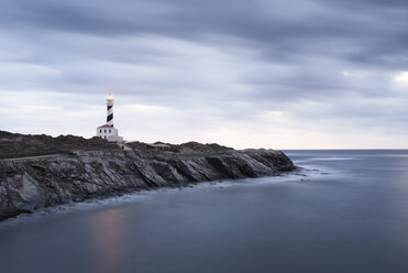 Spain, Balearic Islands, Menorca, Favaritx lighthouse surrounded by clouds in the morning - IGGF00267