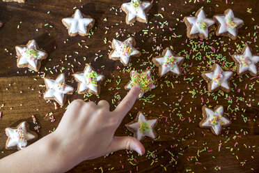 Girl's hand touching cinnamon star - SARF03451