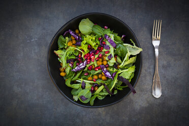 Bowl of mixed leaf salad with pomegranate seed, red cabbage and roasted curcuma chick peas - LVF06516