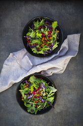 Bowl of mixed leaf salad with pomegranate seed, red cabbage and roasted curcuma chick peas - LVF06518