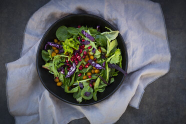 Bowl of mixed leaf salad with pomegranate seed, red cabbage and roasted curcuma chick peas - LVF06520