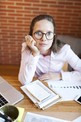 Portrait of businesswoman at desk in office - VABF01439