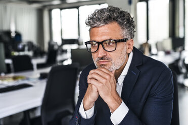 Portrait of serious mature businessman wearing glasses in office - HAPF02529