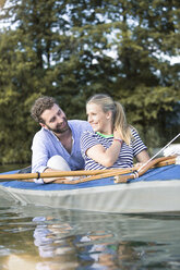 Happy young couple enjoying a canoe trip - FKF02820