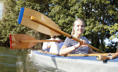 Young couple enjoying a trip in a canoe on a lake - FKF02825