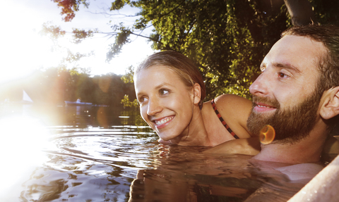 Happy young couple in a lake stock photo