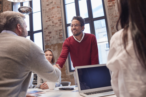 Colleagues greeting at a presentation in the office stock photo