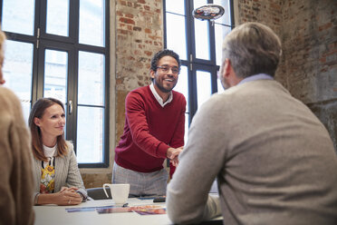 Colleagues greeting ata presentation in the office at a business meeting - WESTF23846