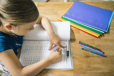 Girl doing homework at table - MOEF00556