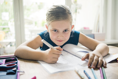 Portrait of girl doing homework at table - MOEF00557