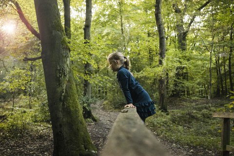 Girl playing in forest stock photo