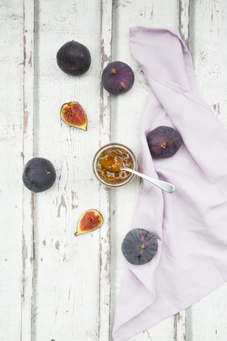 Organic figs and a glass of fig jam on a wood stock photo