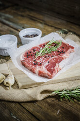 Raw beefsteak with rosemary, salt and pepper - GIOF03687