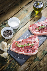 Raw beefsteak with rosemary, salt and pepper - GIOF03689
