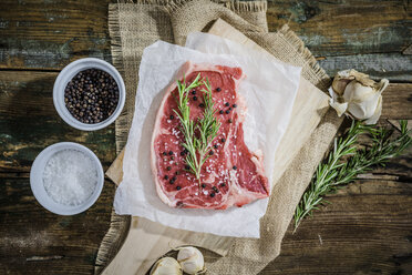 Raw beefsteak with rosemary, salt and pepper - GIOF03690